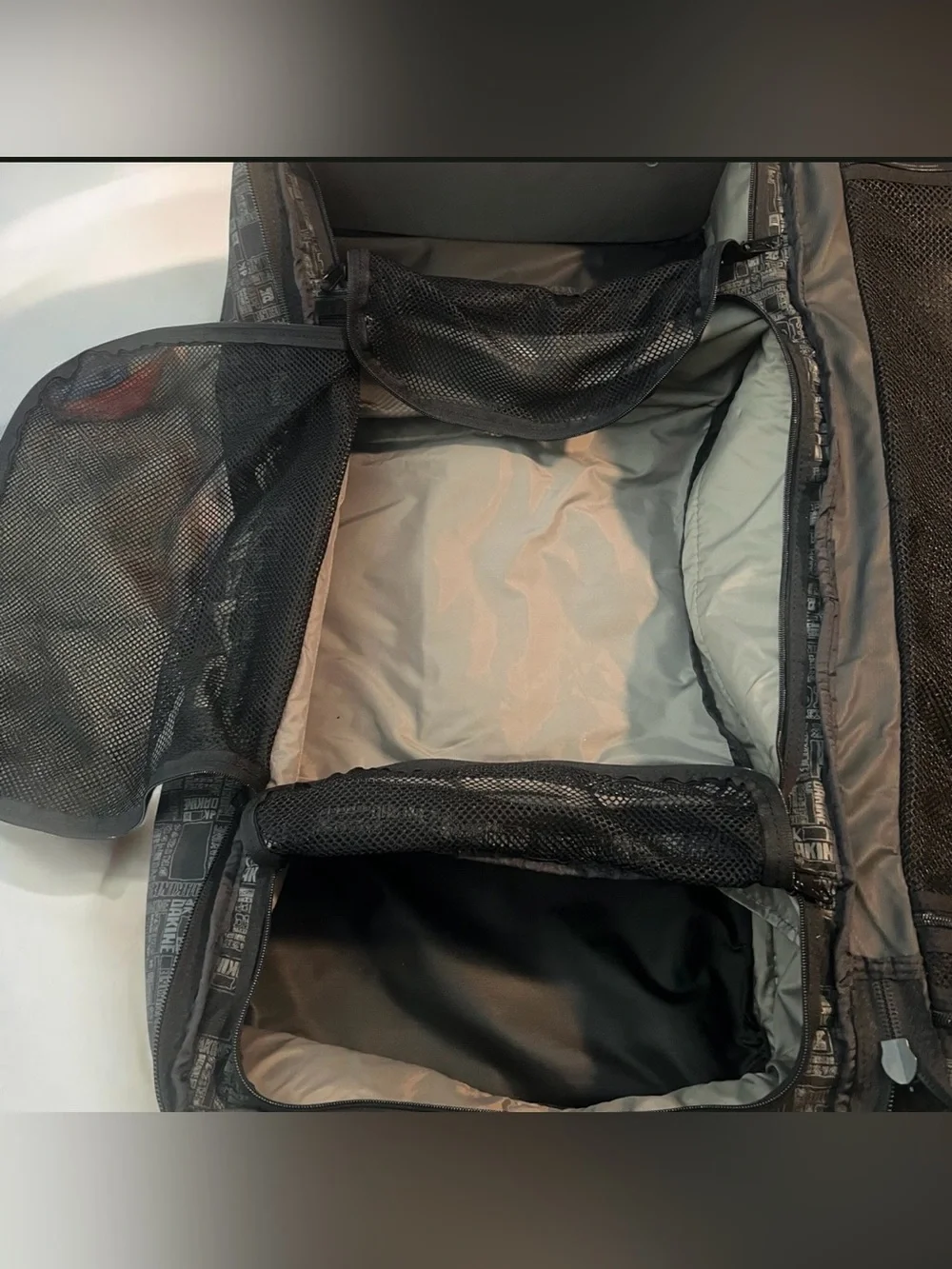 Dakine Split Roller 110L Wet Dry Duffel with a distinctive geometric pattern.